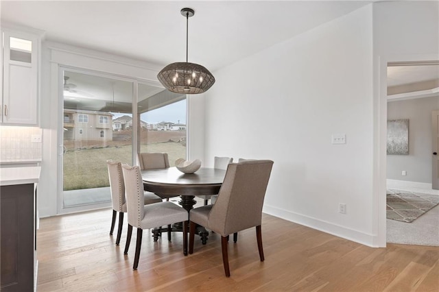 dining room featuring an inviting chandelier and light hardwood / wood-style flooring