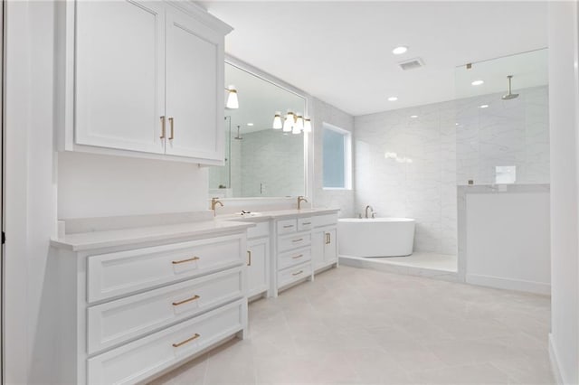 bathroom with independent shower and bath, tile patterned flooring, and vanity