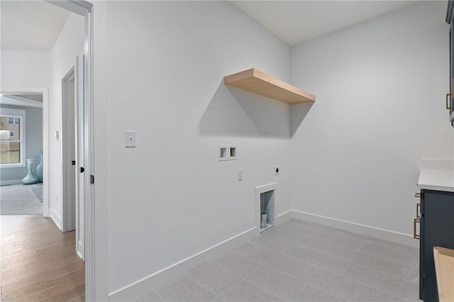 washroom featuring hookup for a washing machine, hookup for an electric dryer, and light hardwood / wood-style flooring