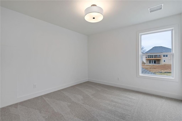 empty room with carpet flooring and plenty of natural light