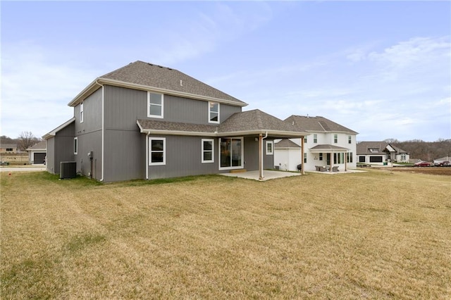 back of house with central AC unit, a lawn, and a patio area