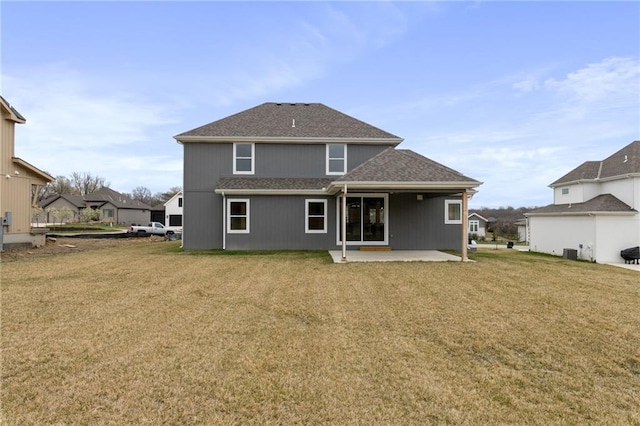 back of property with a patio area and a yard