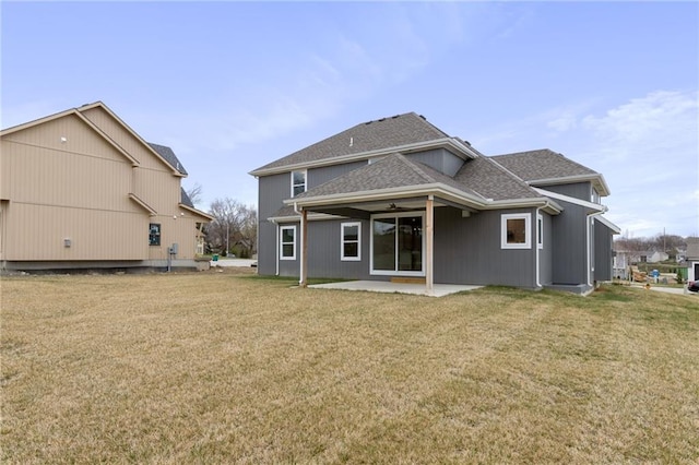 rear view of property featuring a patio area and a yard