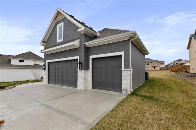 exterior space featuring a garage and a lawn