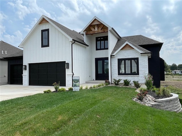 modern farmhouse featuring a garage and a front lawn