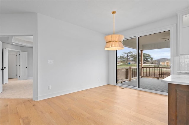 unfurnished dining area with light wood-type flooring