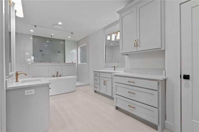 bathroom featuring vanity and separate shower and tub