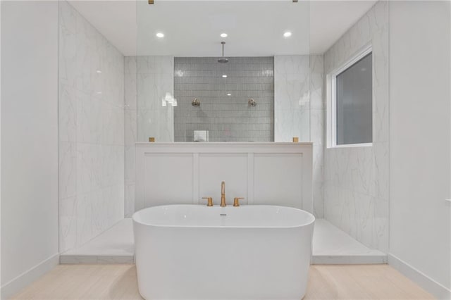 bathroom featuring hardwood / wood-style floors and separate shower and tub