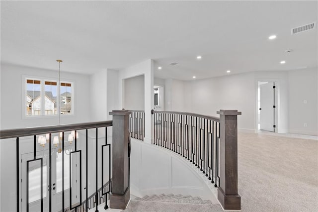 hallway with light colored carpet