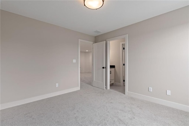 unfurnished room featuring light colored carpet