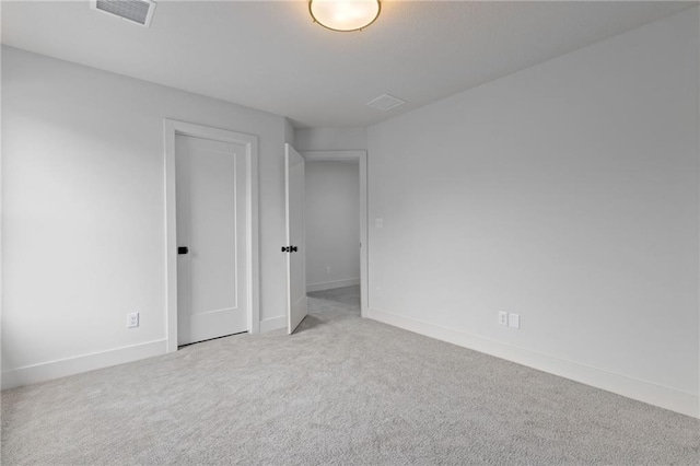 empty room with light colored carpet