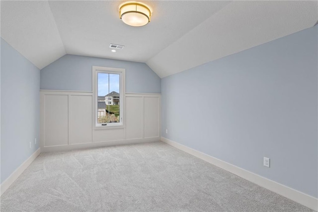 bonus room featuring light colored carpet and lofted ceiling