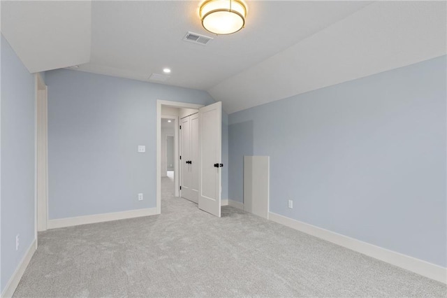 bonus room featuring light colored carpet and vaulted ceiling