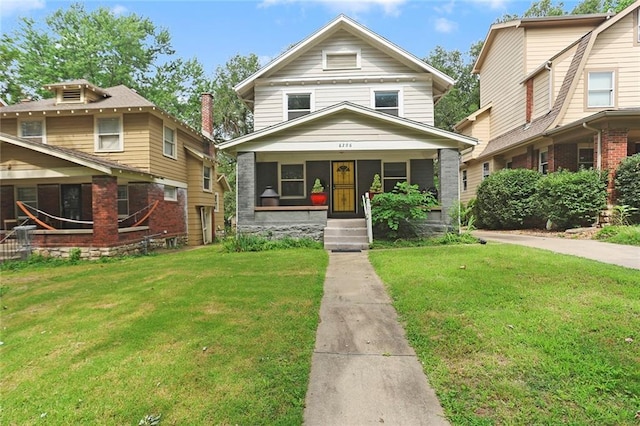6206 Harrison St, Kansas City, MO 64110 - traditional style home with a front lawn and covered porch