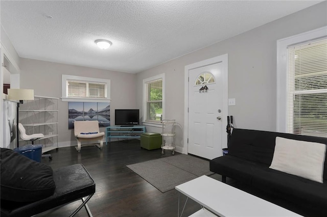 6206 Harrison St, Kansas City, MO 64110 - living area featuring wood finished floors, a textured ceiling, and baseboards