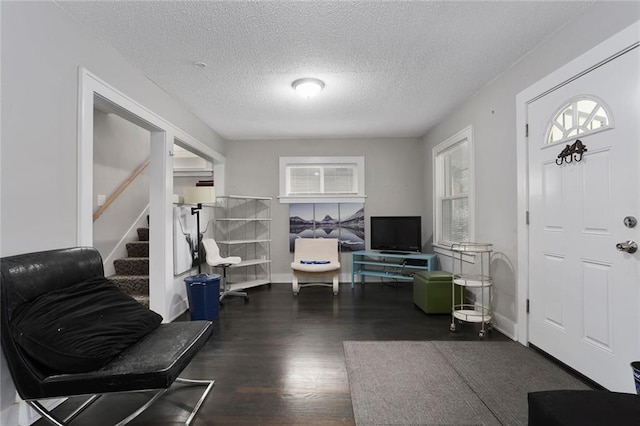 6206 Harrison St, Kansas City, MO 64110 - entryway with wood finished floors, stairway, a textured ceiling, and baseboards