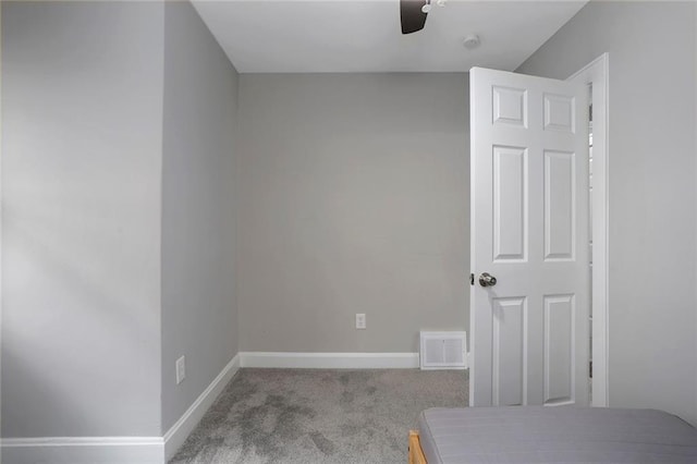 unfurnished bedroom with ceiling fan and light colored carpet