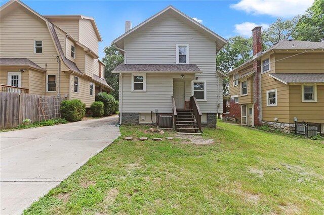 6206 Harrison St, Kansas City, MO 64110 - back of house featuring concrete driveway and central air condition unit