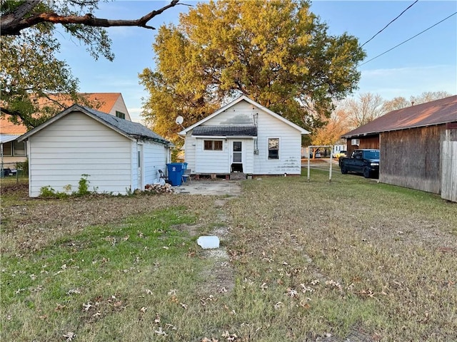 rear view of house with a yard