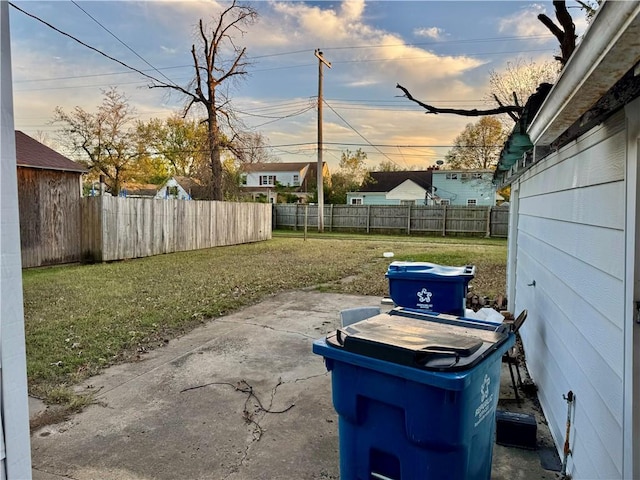 yard at dusk featuring a patio