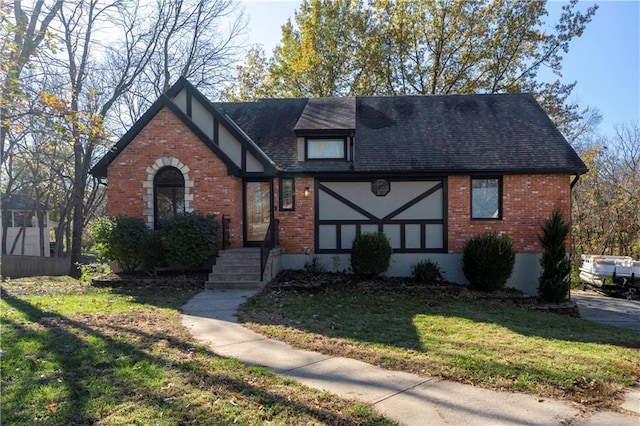 tudor house featuring a front lawn