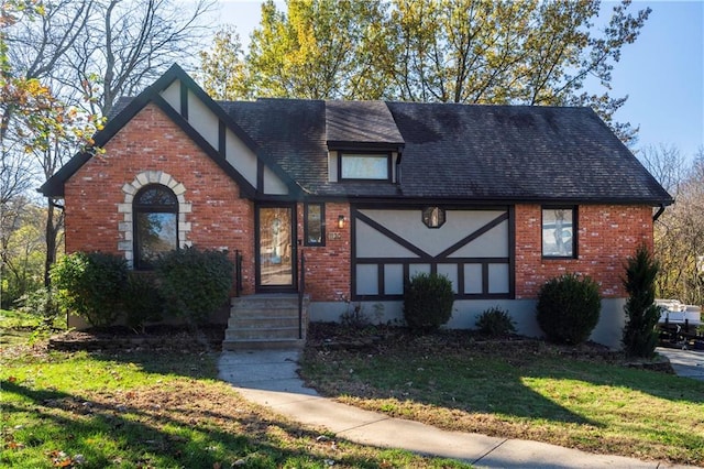 tudor home with a front lawn