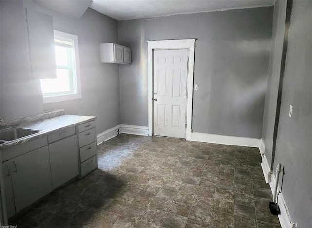 kitchen with gray cabinetry and sink