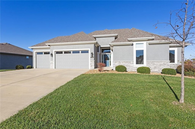 prairie-style house featuring a garage and a front yard