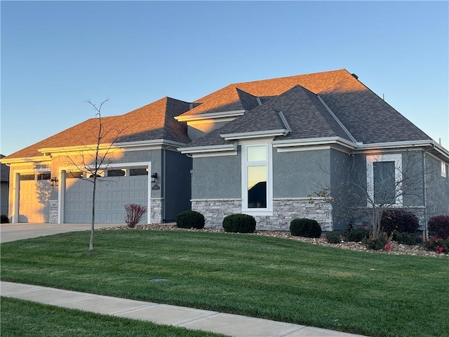 view of front of property featuring a garage and a front lawn