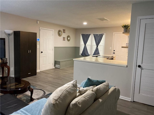 living room featuring a textured ceiling and hardwood / wood-style flooring