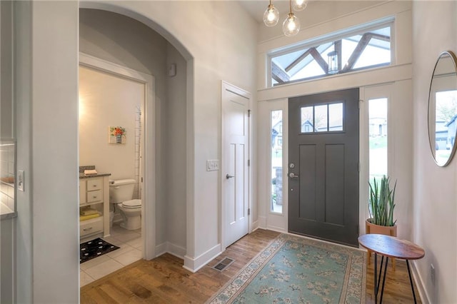 entryway with light hardwood / wood-style floors and vaulted ceiling