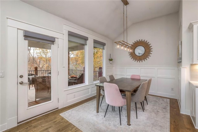 dining space with vaulted ceiling and dark hardwood / wood-style floors