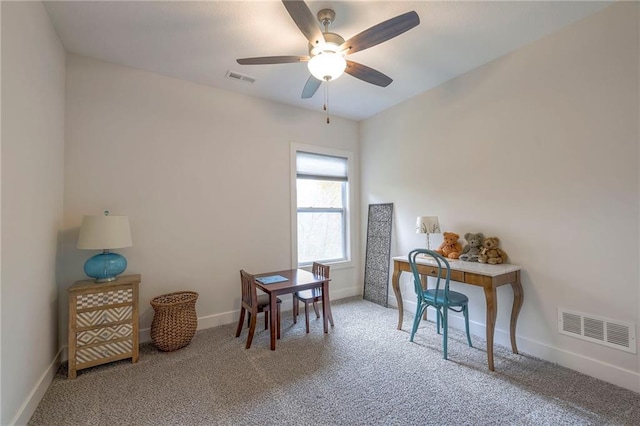 carpeted office space featuring ceiling fan