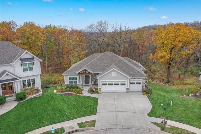 view of front of home with a front yard and a garage