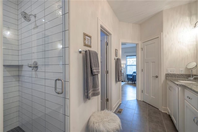 bathroom featuring vanity, tile patterned flooring, and a shower with shower door