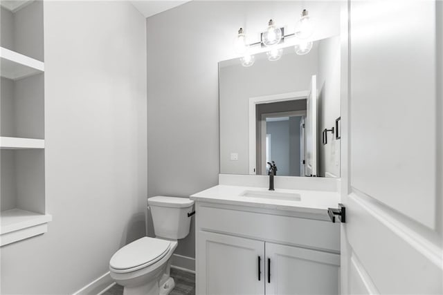 bathroom featuring vanity, toilet, and hardwood / wood-style floors