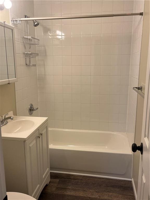 full bathroom with toilet, vanity, tiled shower / bath, and wood-type flooring