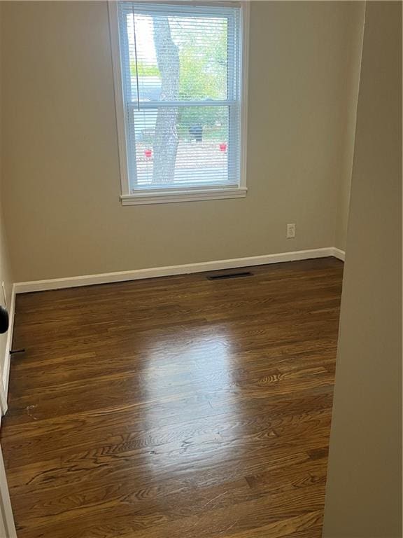 unfurnished room featuring dark hardwood / wood-style flooring