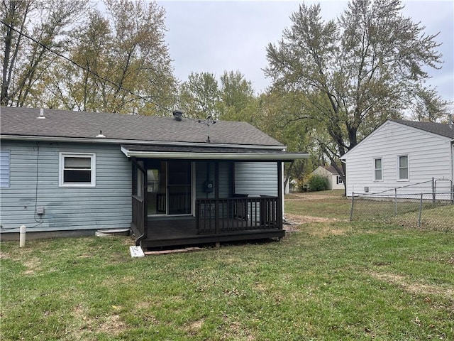 rear view of property with a yard