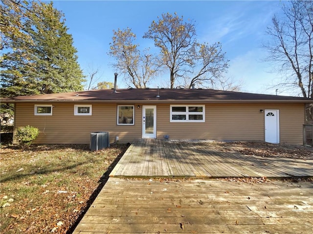 rear view of property featuring a wooden deck