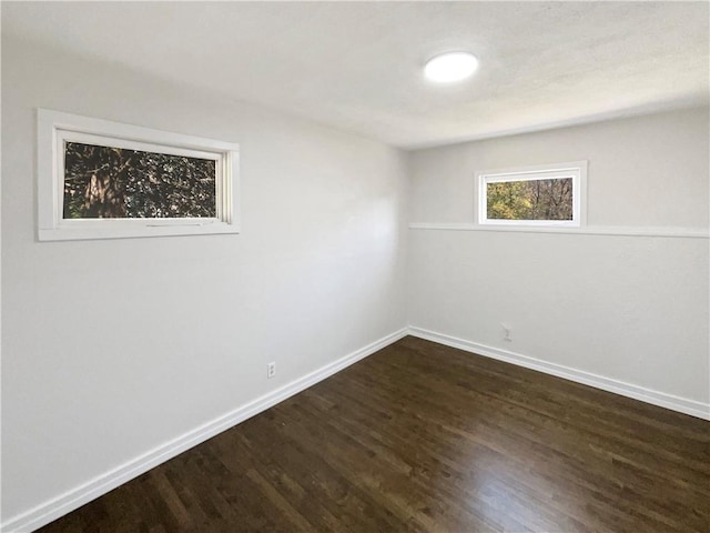 empty room featuring dark hardwood / wood-style flooring