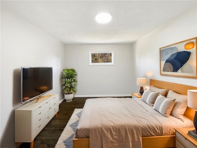 bedroom featuring dark wood-type flooring and a textured ceiling