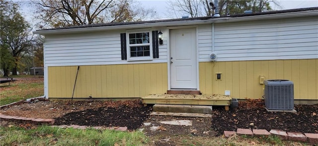 entrance to property featuring cooling unit