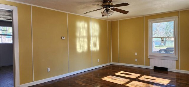 unfurnished room with ceiling fan, dark hardwood / wood-style floors, and crown molding