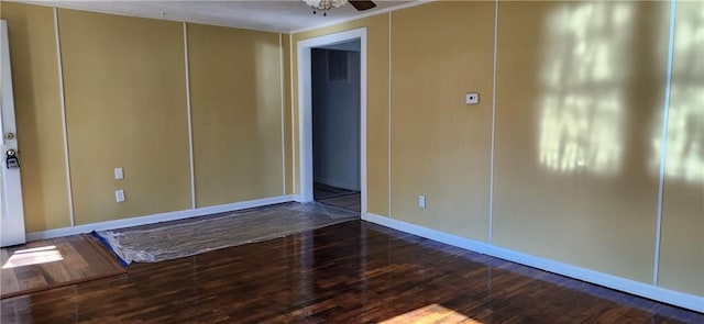 spare room with ceiling fan and dark hardwood / wood-style floors