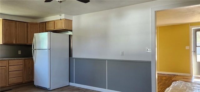 kitchen with dark hardwood / wood-style flooring, white refrigerator, and ceiling fan