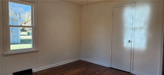 unfurnished bedroom with dark wood-type flooring