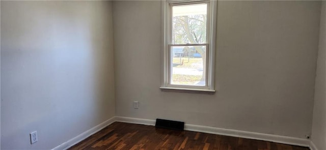 empty room featuring dark hardwood / wood-style flooring