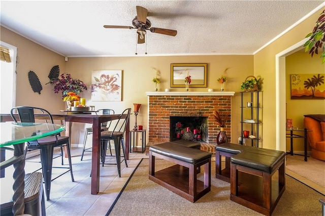 carpeted living room with a fireplace, a textured ceiling, ceiling fan, and crown molding