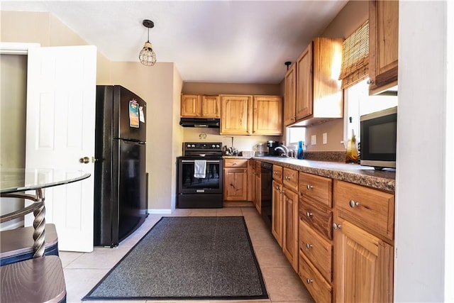 kitchen featuring hanging light fixtures, light tile patterned floors, black appliances, and sink